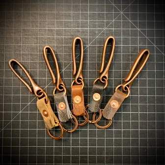 Product image of Antiqued Copper Japanese Fishhook keychain with Bison leather and copper post and burr rivet.